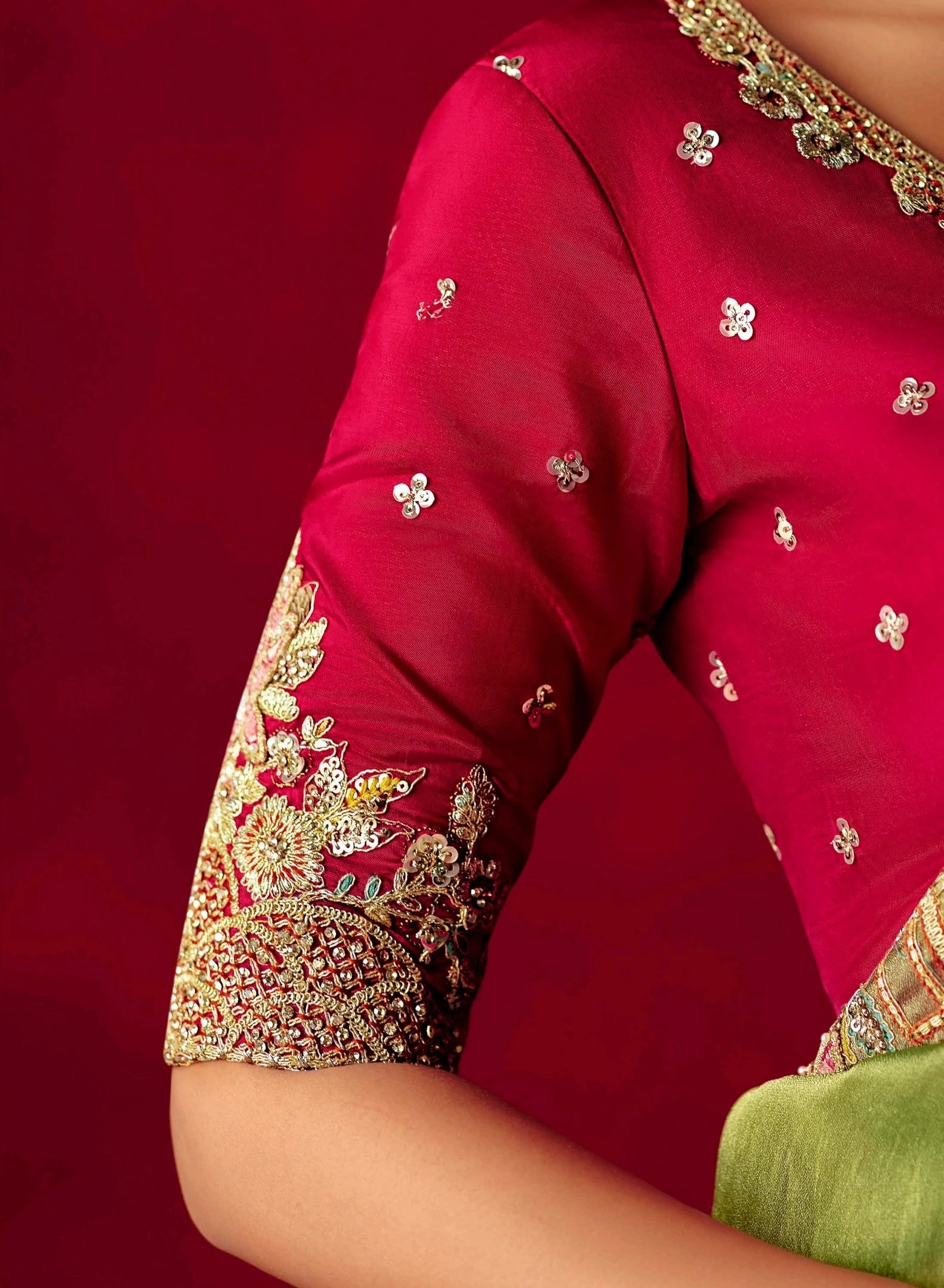 Red saree with gold embroidery on a red background